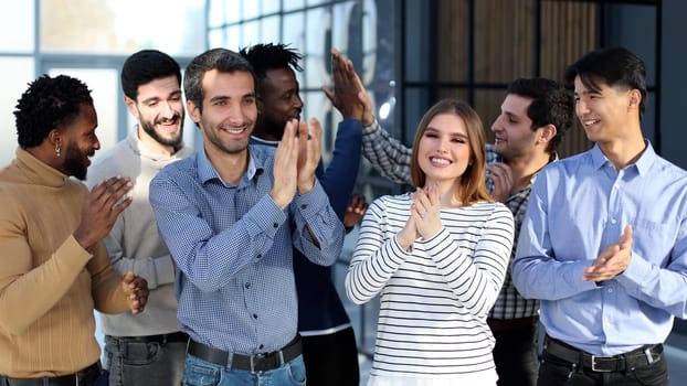 happy excited millennial employees shouting for joy, raising hands for emotional high fives.
