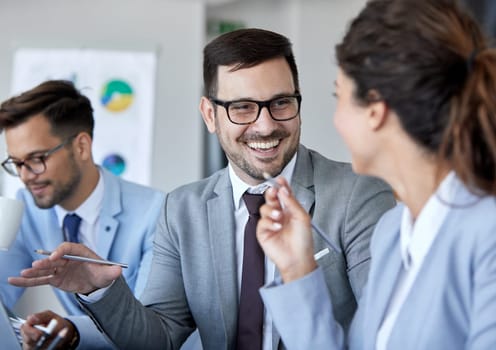 A portrait of a young businesspeople talking smiling during a meeting and presentation in the office. Business concept