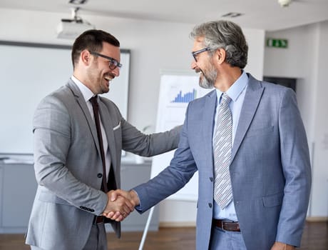 Successful businesspeople shaking hands and making an agreement during a meeting in an office. Business concept