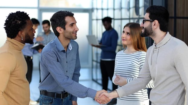 Group of smiling young business people discussing new ideas