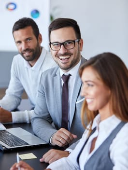 A portrait of a young smiling businessman a meeting and presentation in the office. Business concept