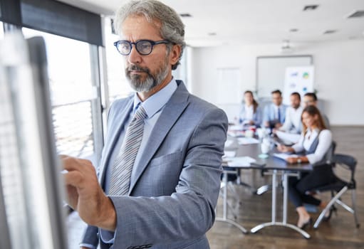 Senior busnessman writing and having a representation and speech by a whiteboard during a conference business meeting in an office. Business concept