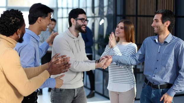 Smiling business team standing and talking during a meeting