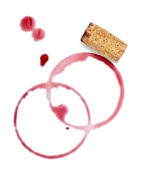 close up of a wine stain and corkscrew and cork cap on white background