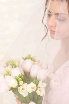 Wedding bouquet of pink tulips in bride's hands