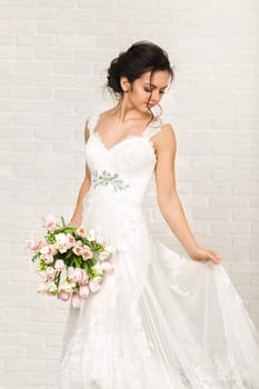 Portrait of beautiful bride with wedding bouquet of pink tulips
