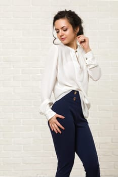 portrait of a beautiful happy brunette woman in a white blouse