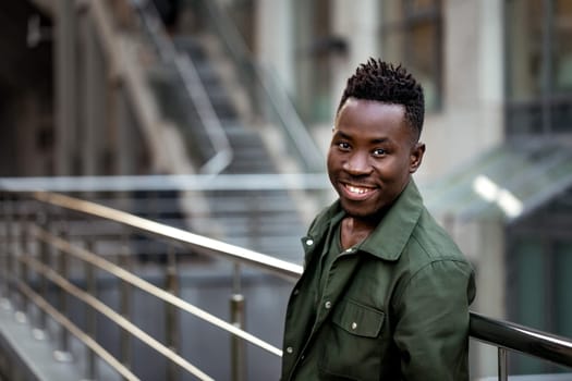african-american man in stylish jacket on city street in the evening. copy space for text