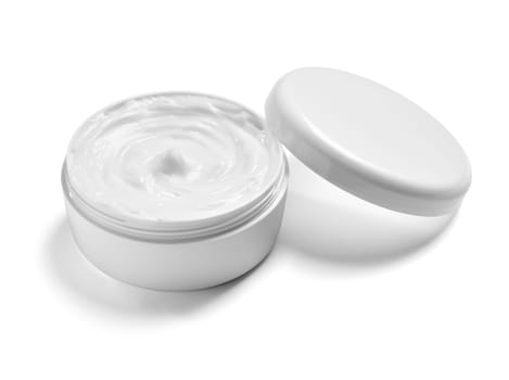 close up of a white beauty cream in a container on white background