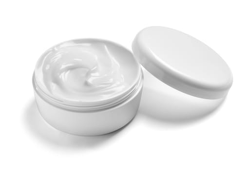 close up of a white beauty cream in a container on white background
