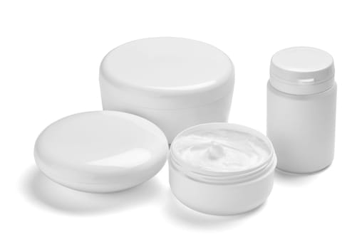 close up of a white beauty cream container and tube on white background