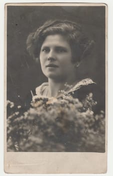 THE CZECHOSLOVAK REPUBLIC - CIRCA 1930s: Vintage photo shows a young woman - Edwardian hairstyle. Retro black and white photography. Circa 1930s.