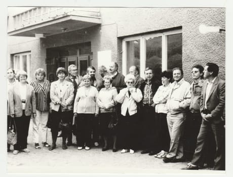 THE CZECHOSLOVAK SOCIALIST REPUBLIC - CIRCA 1980s: Vintage photo shows a group of people poses outdoors. Retro black and white photography. Circa 1980s.