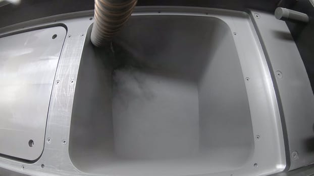 Pouring metal powder into working surface of 3D printer for metal. SLM. Selective laser melting technology. Flowing Metal Powder inside 3d printer for metal. Filling working chamber with powder.
