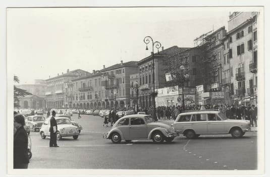ITALY - CIRCA 1970s: Vintage photo shows the heavy traffic in Italian town. Retro black and white photography. Circa 1970s.