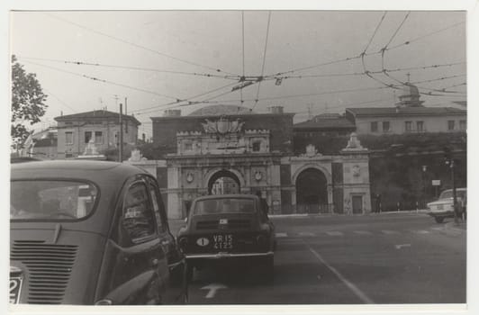 ITALY - CIRCA 1970s: Vintage photo shows the heavy traffic in Italian town. Retro black and white photography. Circa 1970s.