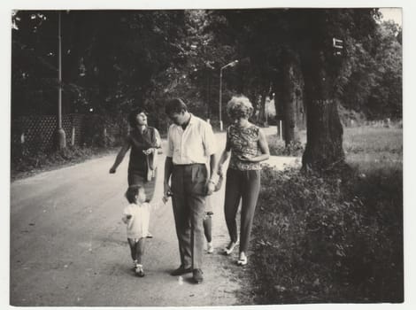 THE CZECHOSLOVAK SOCIALIST REPUBLIC - CIRCA 1970s: Vintage photo shows people go for a walk. Retro black and white photography. Circa 1970s.