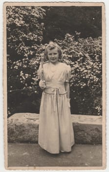 THE CZECHOSLOVAK REPUBLIC - CIRCA 1940s: Vintage photo shows girl after her first communion. Retro black and white photography. Circa 1970s.