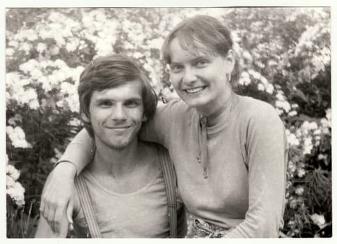 THE CZECHOSLOVAK SOCIALIST REPUBLIC - MAY 1982: Vintage photo shows a teenager siblings - brother and sister pose outdoors. Retro black and white photography. Circa 1980s.