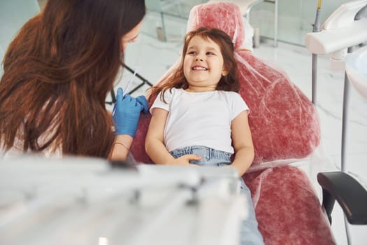 Little girl visiting dentist in clinic. Conception of stomatology.