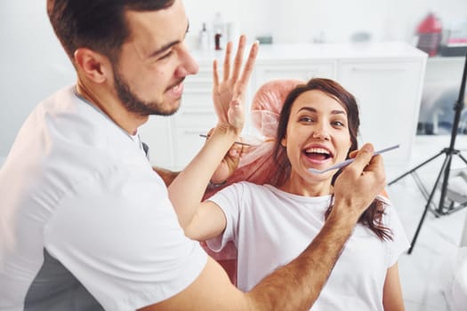 Woman visiting dentist in clinic. Conception of stomatology.