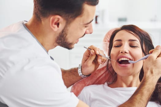 Woman visiting dentist in clinic. Conception of stomatology.