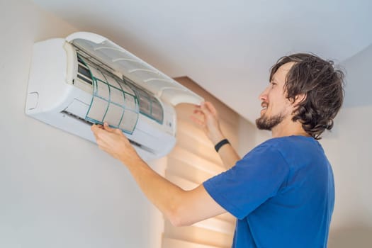 technician service removing air filter of the air conditioner for cleaning.