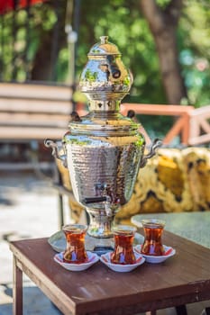Drinking Traditional Turkish Tea with Turkish tea cup and copper tea pot.