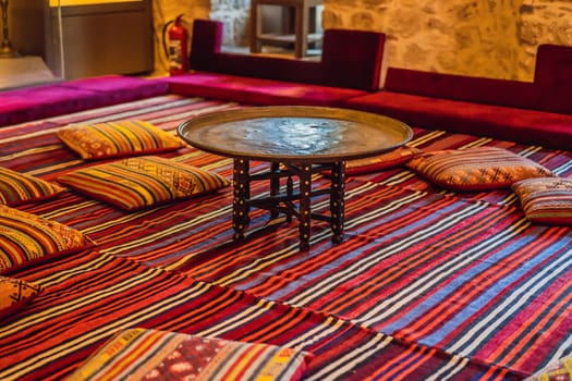 Turkish traditional antique carpets interior. table and pillows.
