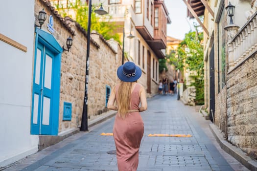 Woman tourist in Old town Kaleici in Antalya. Turkiye. Panoramic view of Antalya Old Town port, Taurus mountains and Mediterrranean Sea, Turkey.