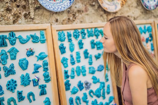 Closeup of beautiful woman looking at Turkish souvenirs for sale in the Grand Bazaar Istanbul, Turkey.