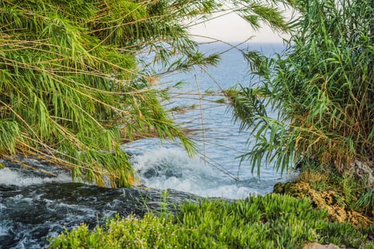 Lower Duden Falls drop off a rocky cliff falling from about 40 m into the Mediterranean Sea in amazing water clouds. Tourism and travel destination photo in Antalya, Turkey. Turkiye