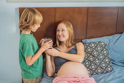 Son brought his pregnant mother a glass of water.