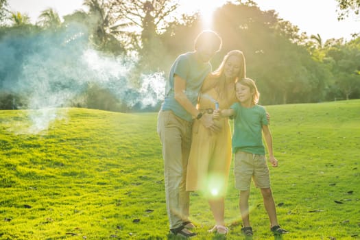 Pregnant mom, dad and son at the gender party on the golf course release blue smoke. Gender reveal announcement on the golf course. Loving family expecting baby boy. Happy moments.