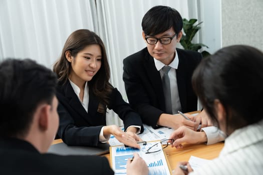 Business team of financial data analysis meeting with business intelligence, report paper and dashboard on laptop for marketing strategy. Business people working together to promote harmony in office.