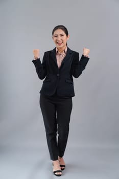 Confident young asian businesswoman in formal suit making hand gesture to indicate promotion or advertising with surprised face expression and gesture on isolated background. Enthusiastic