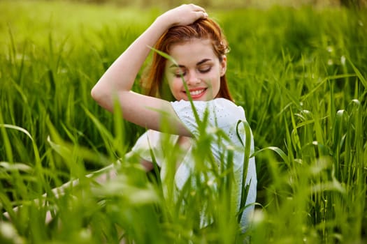beautiful woman enjoying nature sitting in tall grass. High quality photo