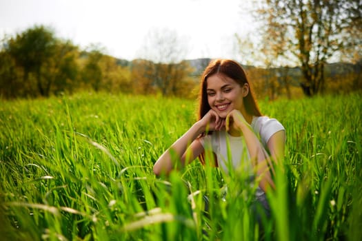 portrait of a happy woman in a white t-shirt with her hands folded in front of her face. High quality photo