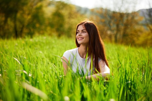 happy cheerful woman laying in green grass. High quality photo