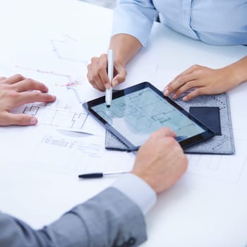 Planning the future. Two architects working together on a digital tablet