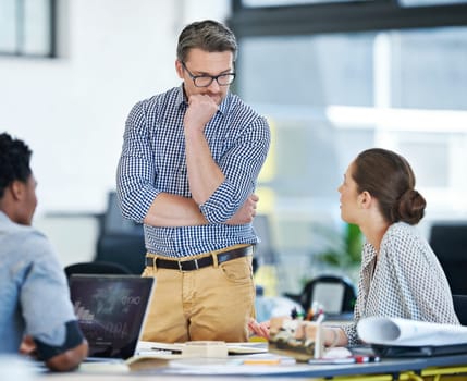 This is going to take some thought...a group of designers working together in an office