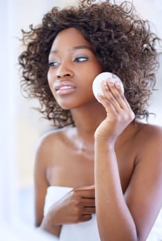 Beauty puff. a beautiful young woman during her daily beauty routine