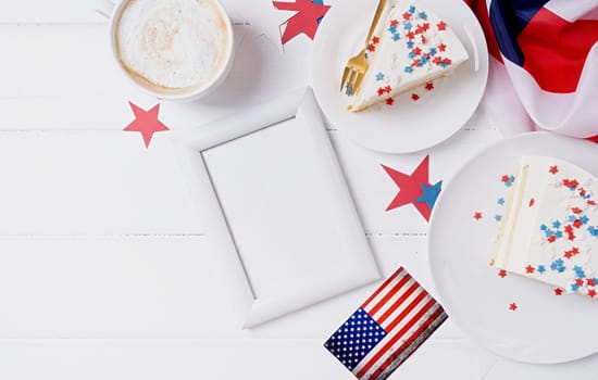 Fourth of july celebration. Sweet cake with usa flag colored sprinkles and stars and white framw for mockup design , flag background top view flat lay