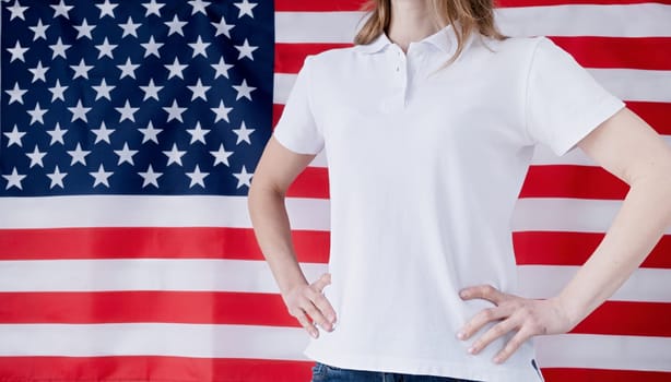 White polo shirt on woman over USA flag background, mockup design. Indoor studio shot