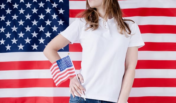 White polo shirt on woman over USA flag background, mockup design. Indoor studio shot