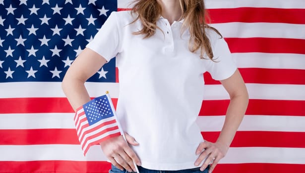 White polo shirt on woman over USA flag background, mockup design. Indoor studio shot