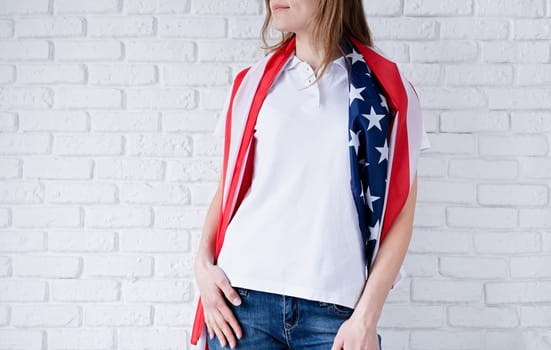 White polo shirt on woman over USA flag background, mockup design. Indoor studio shot