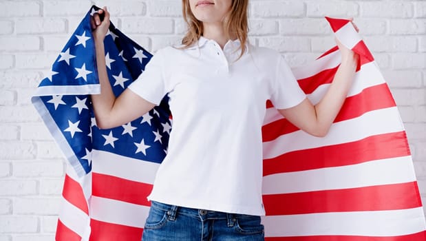 White polo shirt on woman over USA flag background, mockup design. Indoor studio shot