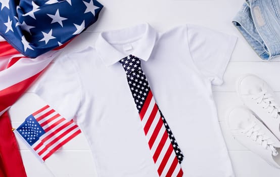 USA Memorial day, Presidents day, Veterans day, Labor day, or 4th of July celebration. Mockup design white polo t shirt for logo, top view on white wooden background with US flag, shoes and jeans