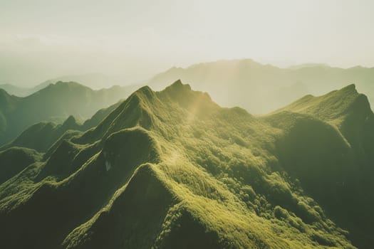 Beautiful sunrise over the green mountains in morning light with fluffy clouds on a bright blue sky. Nature freshness concept.